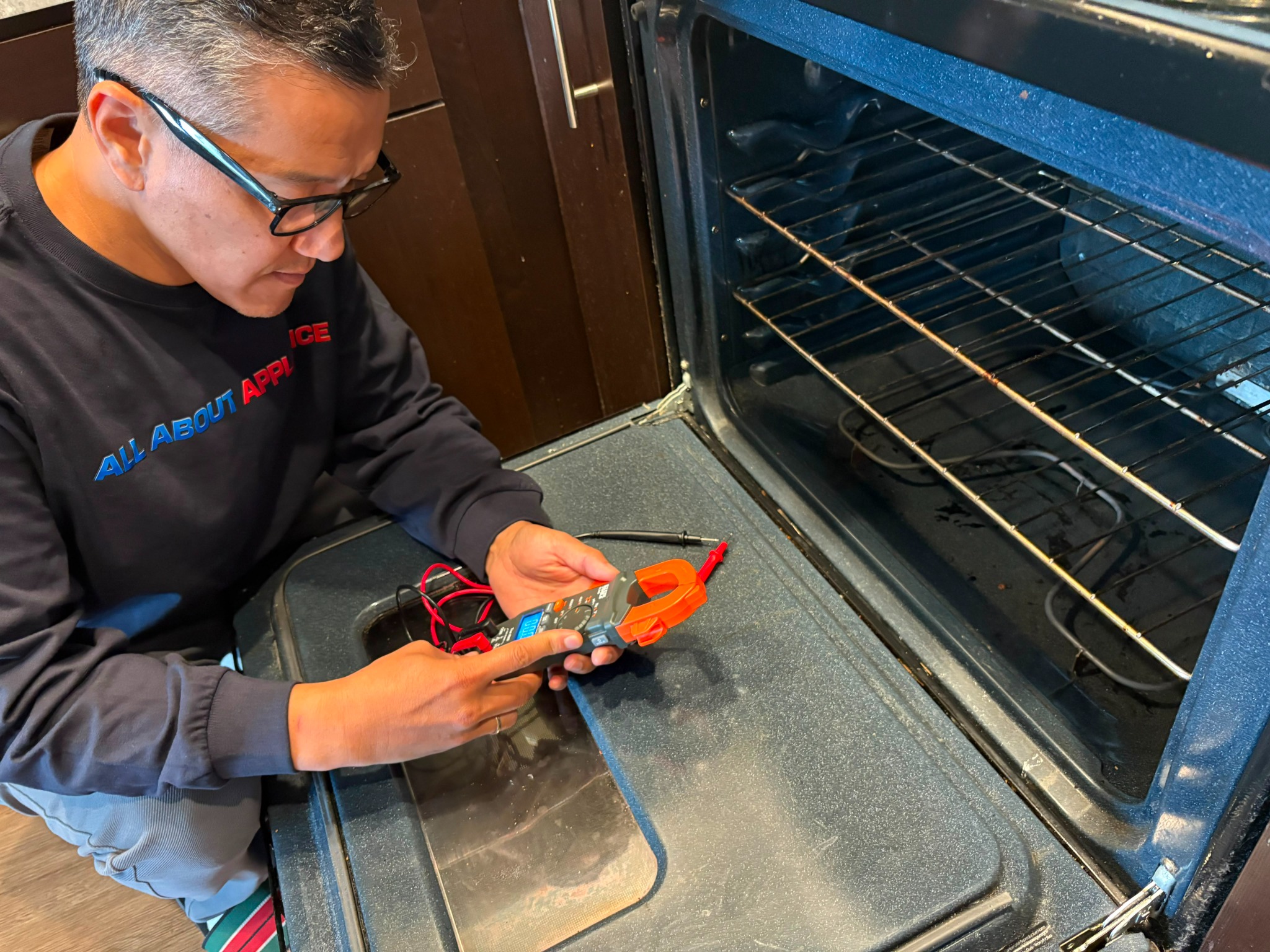 Technician testing an oven during appliance repair